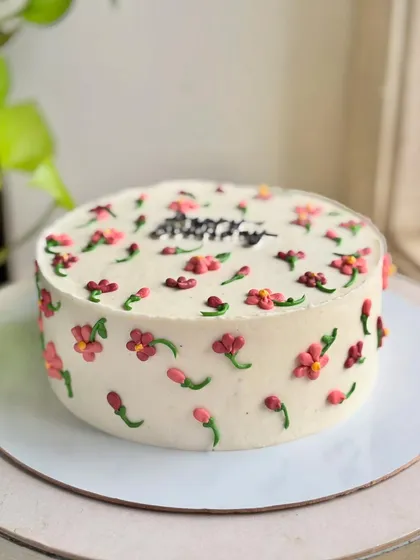 A side view of the minimal blooms cake, showing how the tiny flowers are piped all around for a complete floral look.