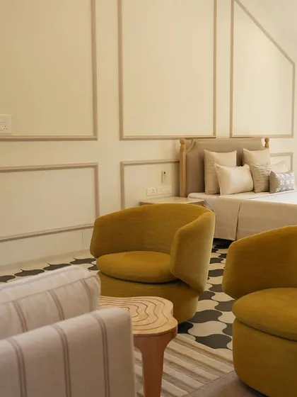 In this Alibaug villa, the master bedroom is a sanctuary of calm. I used a palette of soft neutrals and earthy textures, accented by pops of mustard yellow, to create a space that feels both expansive and deeply restful, a true escape from the city.