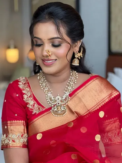A close-up of the soft eye makeup and the traditional nath. Every detail is carefully considered to create a harmonious and elegant bridal look.