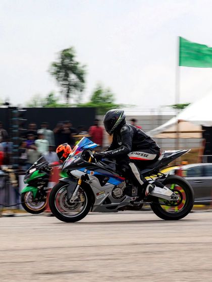 Two superbikes, a BMW and a Kawasaki, race neck and neck. These manufacturer rivalries create thrilling battles for the crowd to enjoy.
