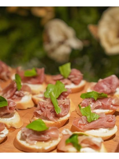 Delicate bruschetta topped with prosciutto and fresh basil. This classic Italian appetizer highlights our commitment to using simple, high quality ingredients to create timeless and delicious canapés.