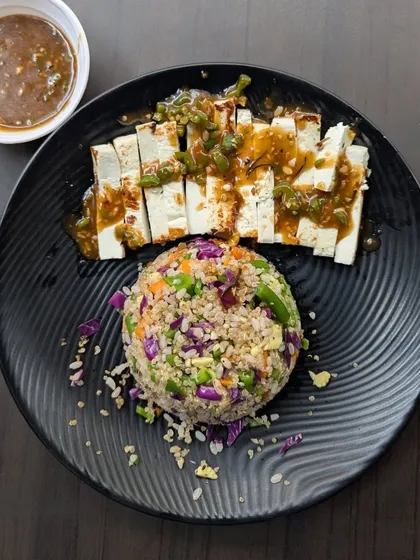 A look at our expertly plated Tofu meal, served with a colorful and nutritious scoop of mixed-grain rice. This dish showcases our focus on creating balanced vegetarian meals that are both flavorful and satisfying.