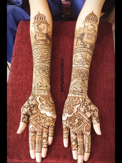 A beautiful representation of a 'doli' scene on the arms. This traditional motif symbolizes the bride's journey to her new home.