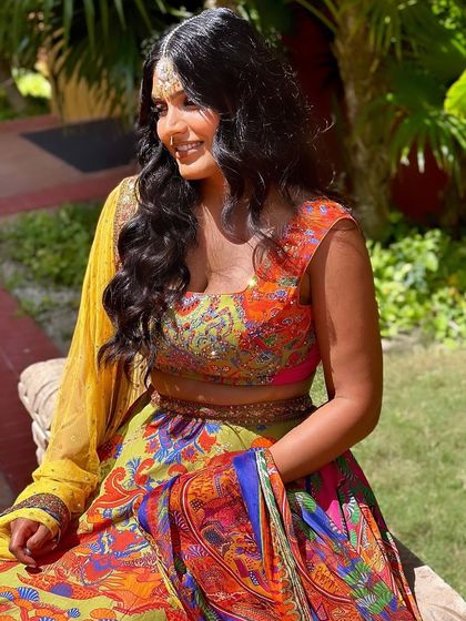 A happy, candid moment of our client enjoying her event while looking radiant in our jewellery.