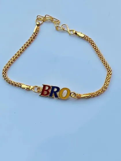 A simple and colorful "BRO" rakhi with red, blue, and yellow enamel letters on a classic gold-tone chain.