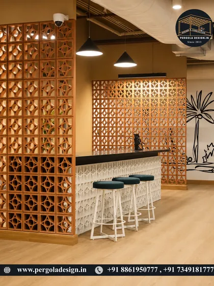 Terracotta jali screens used as a design element in a modern commercial space. These screens act as partitions, providing privacy for a bar area while allowing for airflow and creating a warm, earthy aesthetic.