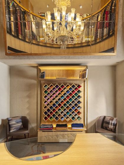 A dedicated display for colorful stoles at Ahujasons is framed by an arch, turning the product into a piece of art. This visual merchandising strategy highlights the beauty of the items and creates a memorable moment in the customer's journey.