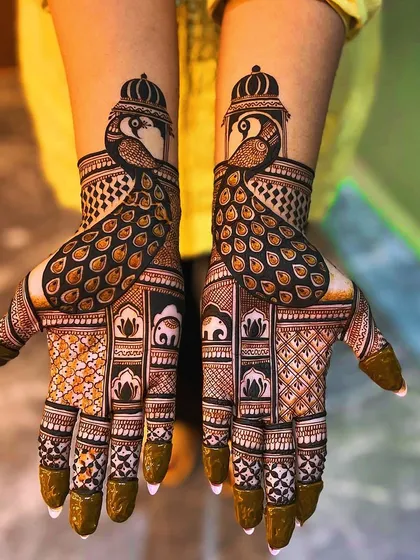Another take on the symmetrical peacock design, with intricate details in the feathers and crowns. This pattern also includes elephant motifs, adding a touch of royalty.