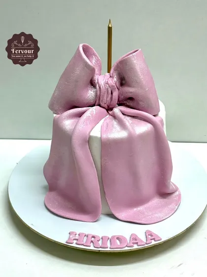 A bow theme cake with a large, hand-crafted pink fondant bow on top. This truffle cake is a great example of how I use fondant for impactful accents.