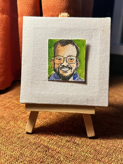 A small watercolour portrait of my partner, Chintan, displayed on an easel. A token of gratitude for his kindness and patience.