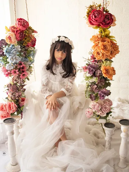 A dreamy portrait on our floral swing. The abundance of colorful flowers creates a stunning, fairytale-like backdrop for this beautiful girl.