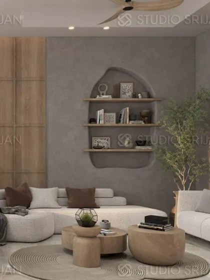 A cozy seating area with a unique curved sofa and a wall with built-in, organically shaped shelves. The use of natural wood and a neutral palette creates a calming, Japandi-style space.