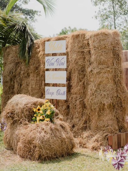 A wider shot of the hay maze entrance, showing the scale of the rustic structure against the palm trees of the Kumarakom venue.