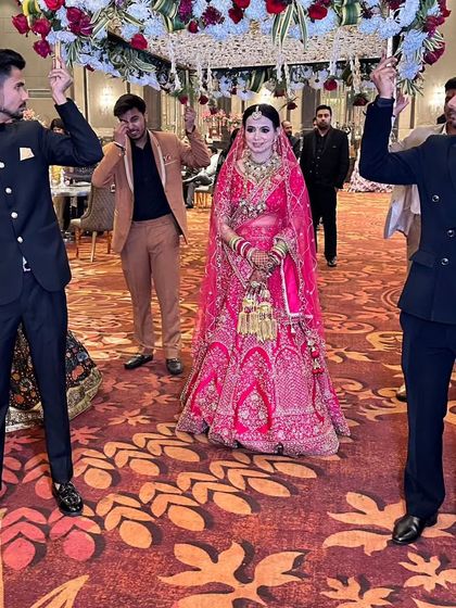 The bride's grand entrance. Her makeup looks flawless and radiant as she walks down the aisle.