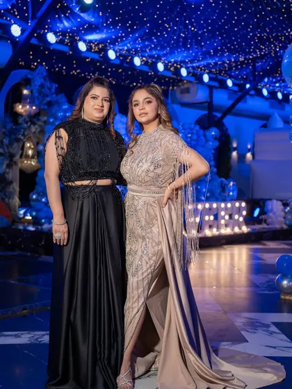 The owner and her family, all decked out in outfits from Mohraya. This photo features a stunning beige gown with fringe details and a chic black co-ord set.