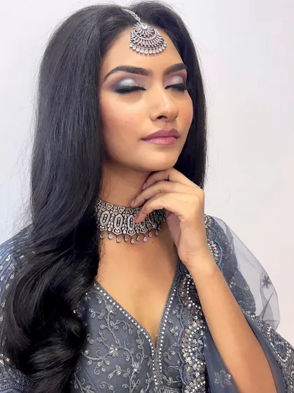 The closed-eye view shows the seamless transition from silver to black, a key technique in creating a professional smokey eye.