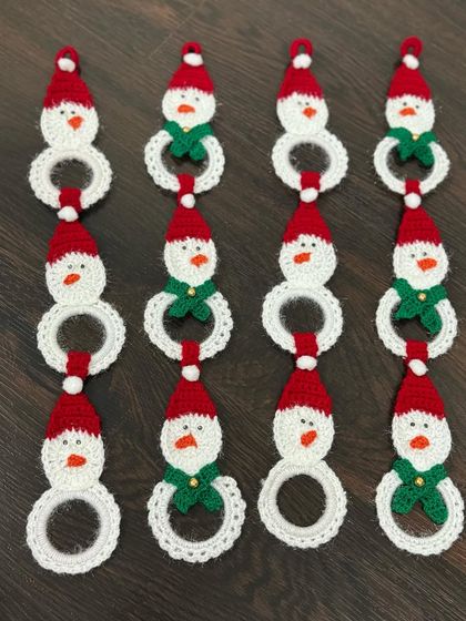 A set of my handmade snowman hangings, ready to adorn a Christmas tree or be used as festive decor around the house. Each one has a little Santa hat and a green scarf.