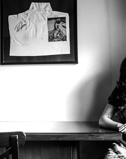 A quiet portrait of a woman at her desk. The composition and lighting tell a story about her space and her thoughts.