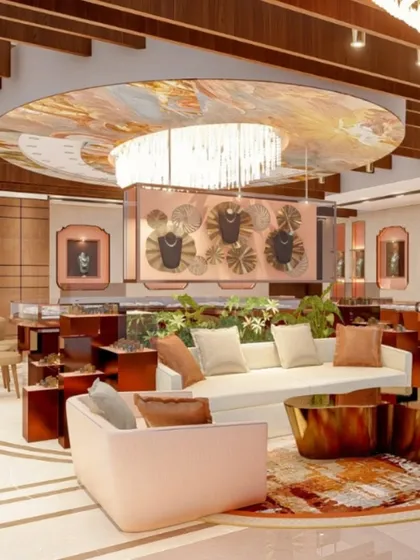 A vibrant and contemporary lounge area within the Batukbhai Jewellers showroom. We used a custom-printed ceiling feature, artistic furniture, and warm metallic accents to create a dynamic and welcoming space for client consultations.