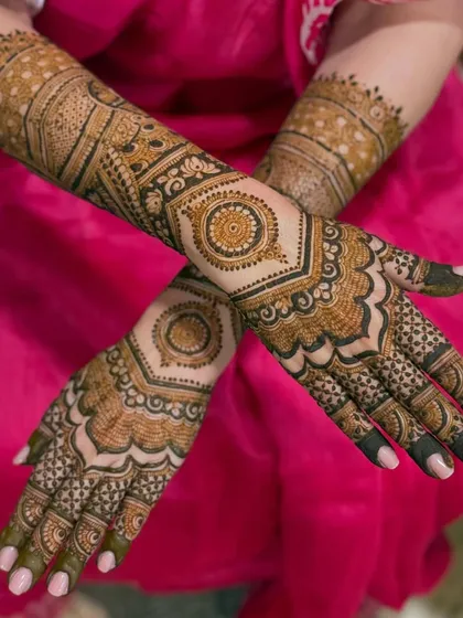 A stylish back-hand design featuring geometric mandalas and cuff-like patterns on the wrist.