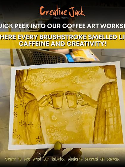 A hand holds up a beautiful piece of coffee art, showing two people toasting with coffee mugs. This is from my unique coffee painting workshop.