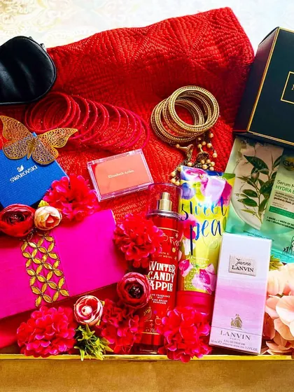 My Karwa Chauth Edit is a tray full of pampering and luxury for that special woman. This arrangement includes a Swarovski piece, premium cosmetics, a silk eye mask, and other indulgent treats in a vibrant red and pink theme.