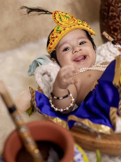 The happiest little Krishna you'll ever see. We focus on capturing your baby's genuine expressions, creating joyful and candid portraits during our themed newborn photoshoots.