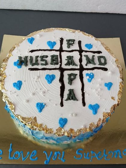 A fun tic-tac-toe themed cake celebrating a man who is a great Husband, Father, and Papa.