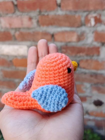 Another angle of the handmade crochet sparrow, showing its side profile and wing detail.