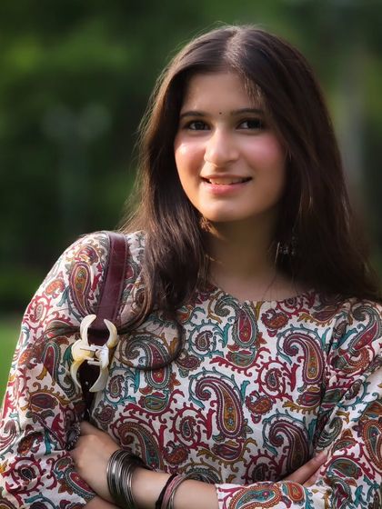 A classic, smiling portrait with a beautifully blurred green background. This kind of clean, happy shot is perfect for a professional profile or social media.