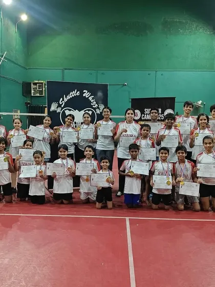 A proud group of our young players and coaches at the Santacruz East branch, showcasing their certificates and medals from a recent event.