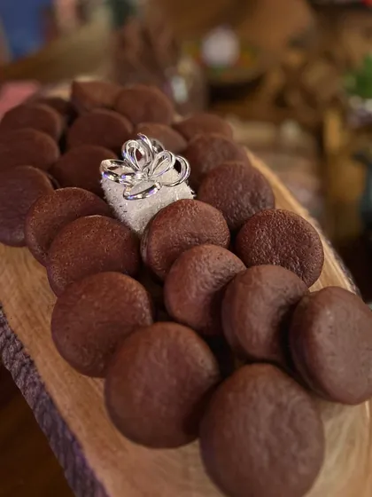 Chocolate whoopie pies on a rustic wooden platter, part of a dessert grazing table. I offer a variety of sweet treats to satisfy every sweet tooth.