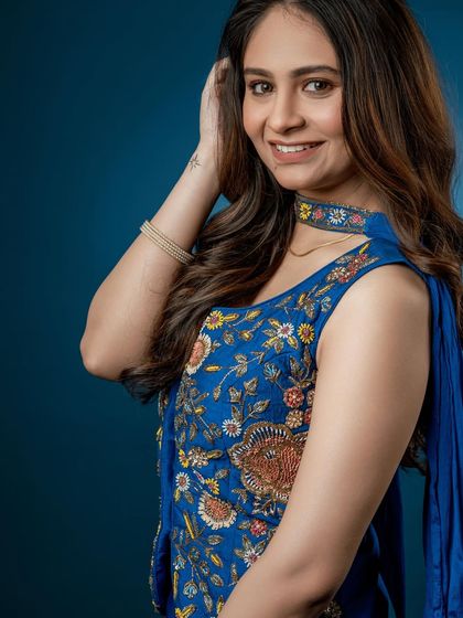 A close-up on the intricate, multi-colored embroidery that makes this Indo-Western piece a true statement outfit.