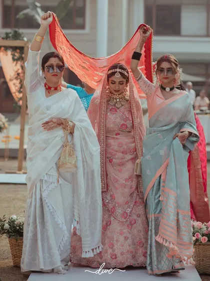 A unique bridal entry, with the bride being escorted by the leading ladies of her family, all looking chic and modern in sunglasses.