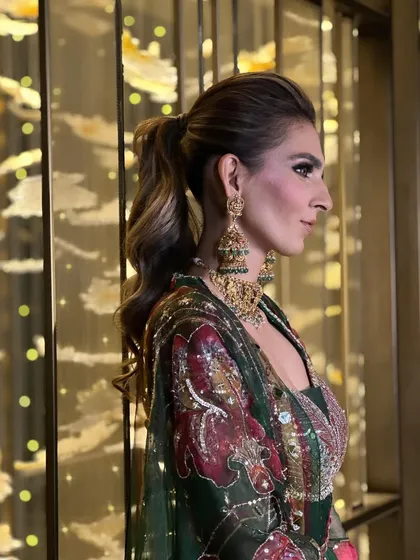 A messy ponytail with lots of texture and volume, ideal for a glamorous cocktail party or sangeet.