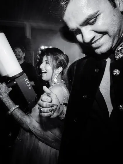 A candid black and white shot of the couple enjoying the party, complete with a CO2 gun for extra fun.