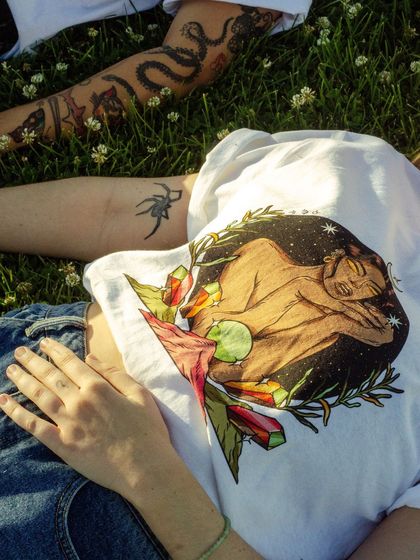 A lifestyle shot of the 'Earth' element T-shirt, showing the design in a natural setting.