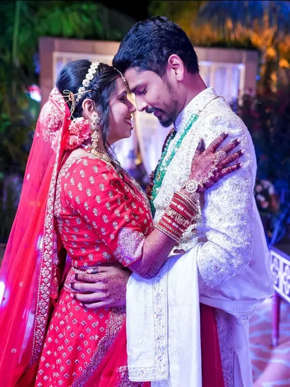 A close, intimate portrait of the couple on their wedding day, their foreheads touching in a gesture of unity and love.