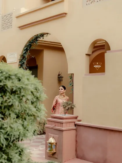 A beautiful shot of the bride at the wedding venue, the architecture and soft light creating a timeless and elegant portrait.