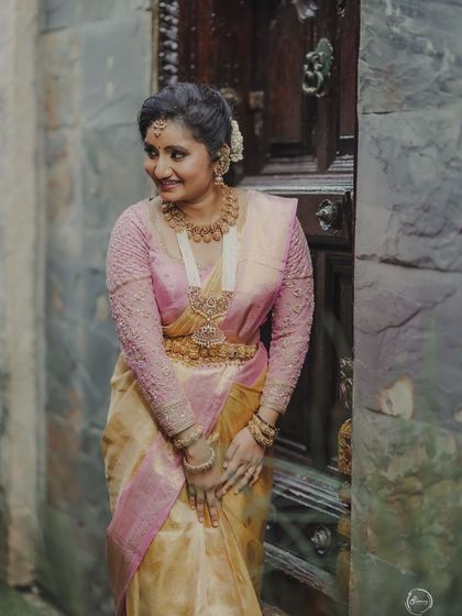 The delicate sheer texture of the tissue silk saree is highlighted in this photo.