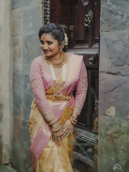 The delicate sheer texture of the tissue silk saree is highlighted in this photo.