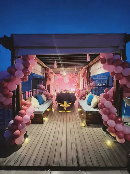 An elegant candlelight dinner setup on a rooftop. We create romantic and memorable experiences for our clients.