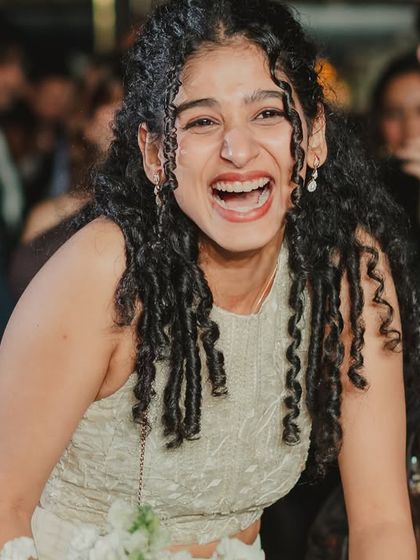 The pure joy on the face of the friend who caught the bouquet. A moment of fun and friendly competition that ended in the best way.