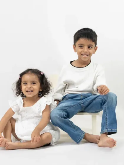A classic portrait of a brother and sister. The simple white studio setup is perfect for capturing timeless photos of your children as they grow.