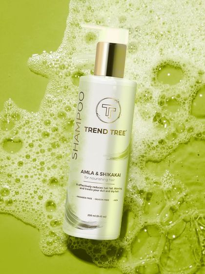 A vibrant shot of Trend Tree shampoo against a green, bubbly water background. This creative setup reinforces the product's purpose and creates a visually exciting image for marketing campaigns.