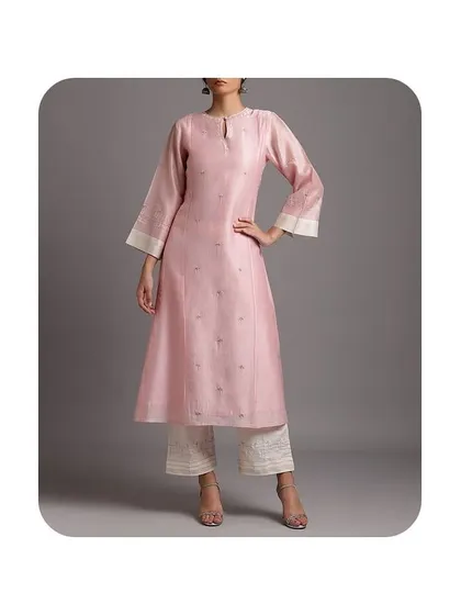 A beautiful pink A-line kurti with flared sleeves. The delicate embroidery and shimmering fabric make this a wonderful choice for special lunches or family gatherings. I ensure the fit is perfect through the torso to create a flattering shape.