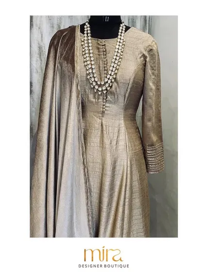The same raw silk kurta set, styled with a statement pearl necklace to show its versatility. The design features handmade potli buttons and delicate embroidery on the sleeves for a touch of understated luxury.