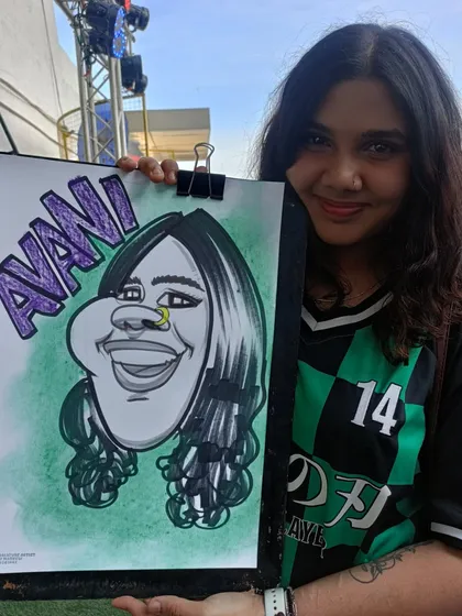A guest in a Demon Slayer shirt with her personalized caricature. It's fun to draw fans in their element.