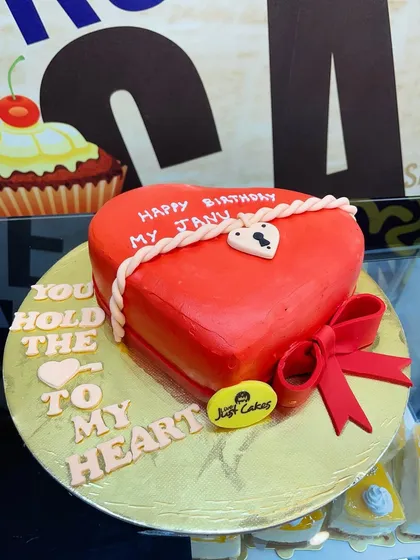 A vibrant red, heart-shaped fondant cake perfect for expressing love on a birthday, anniversary, or Valentine's Day. The intricate rope and lock details add a personalized touch.