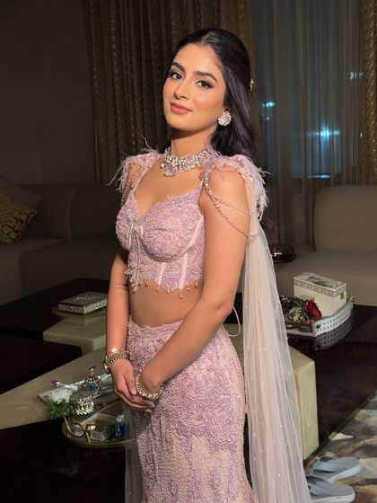 She looks radiant and confident in her pastel couture. The makeup enhances her youthful features and gives her an incredible glow.